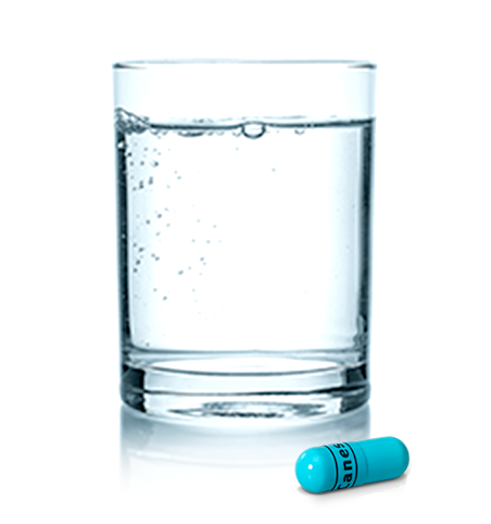 Glass of water and Canesten oral capsule