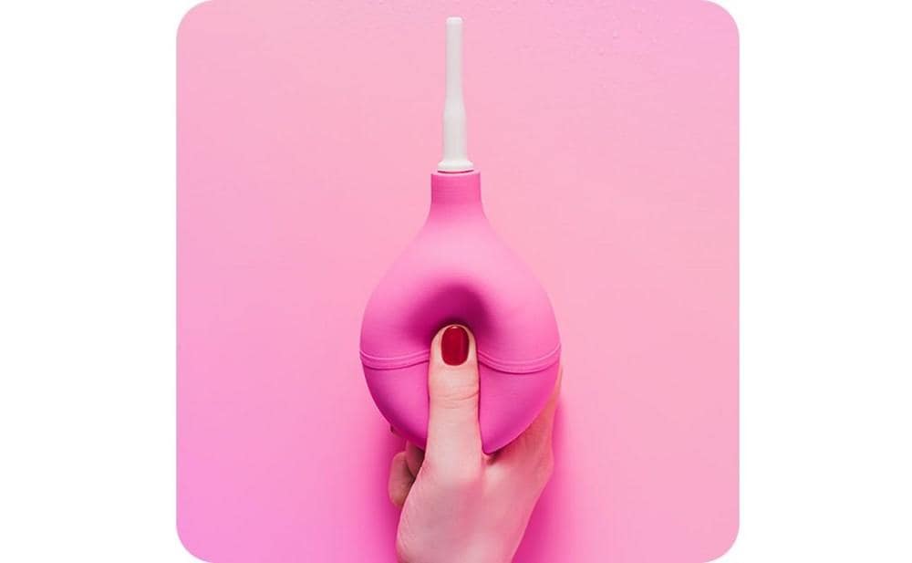 Cropped image of a woman squezing a douche